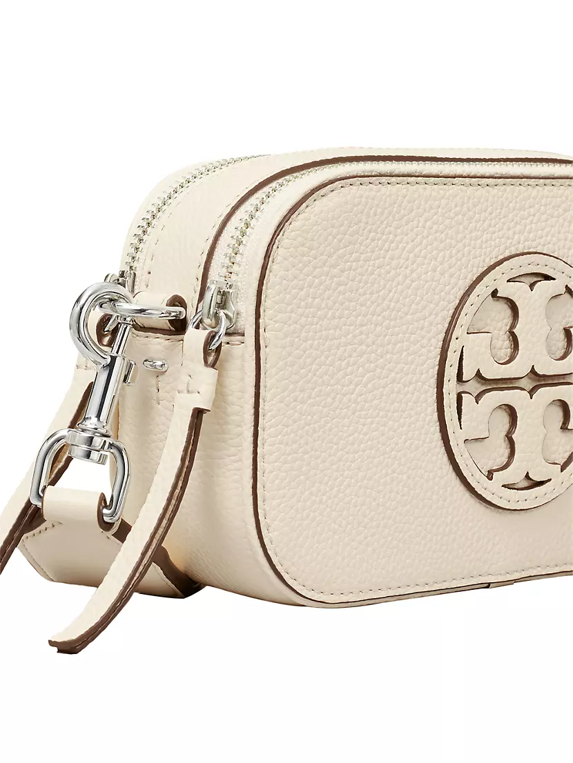 the miller affect carrying a tory burch cognac mini crossbody from