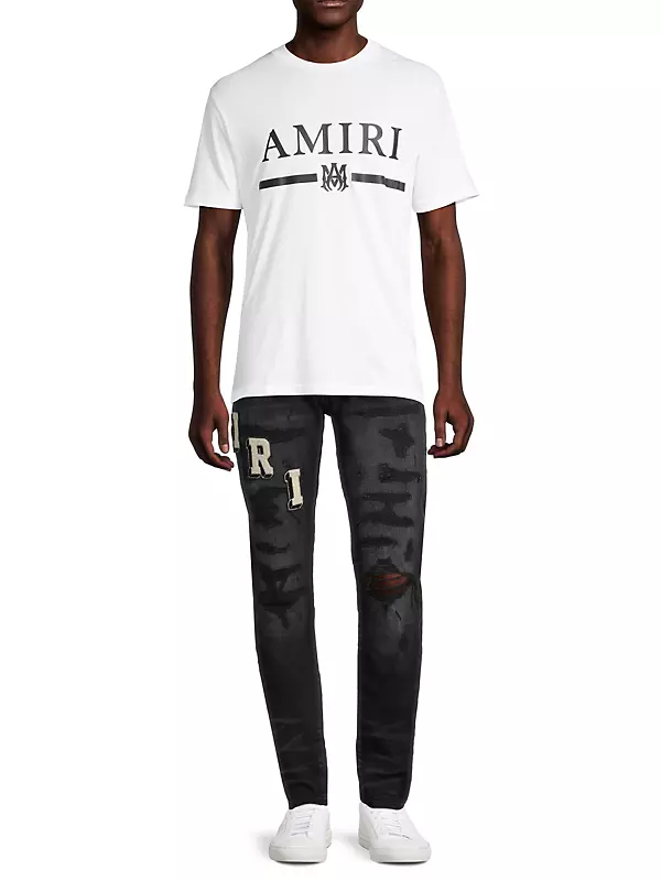 Shop Amiri Distressed Varsity Logo Jeans