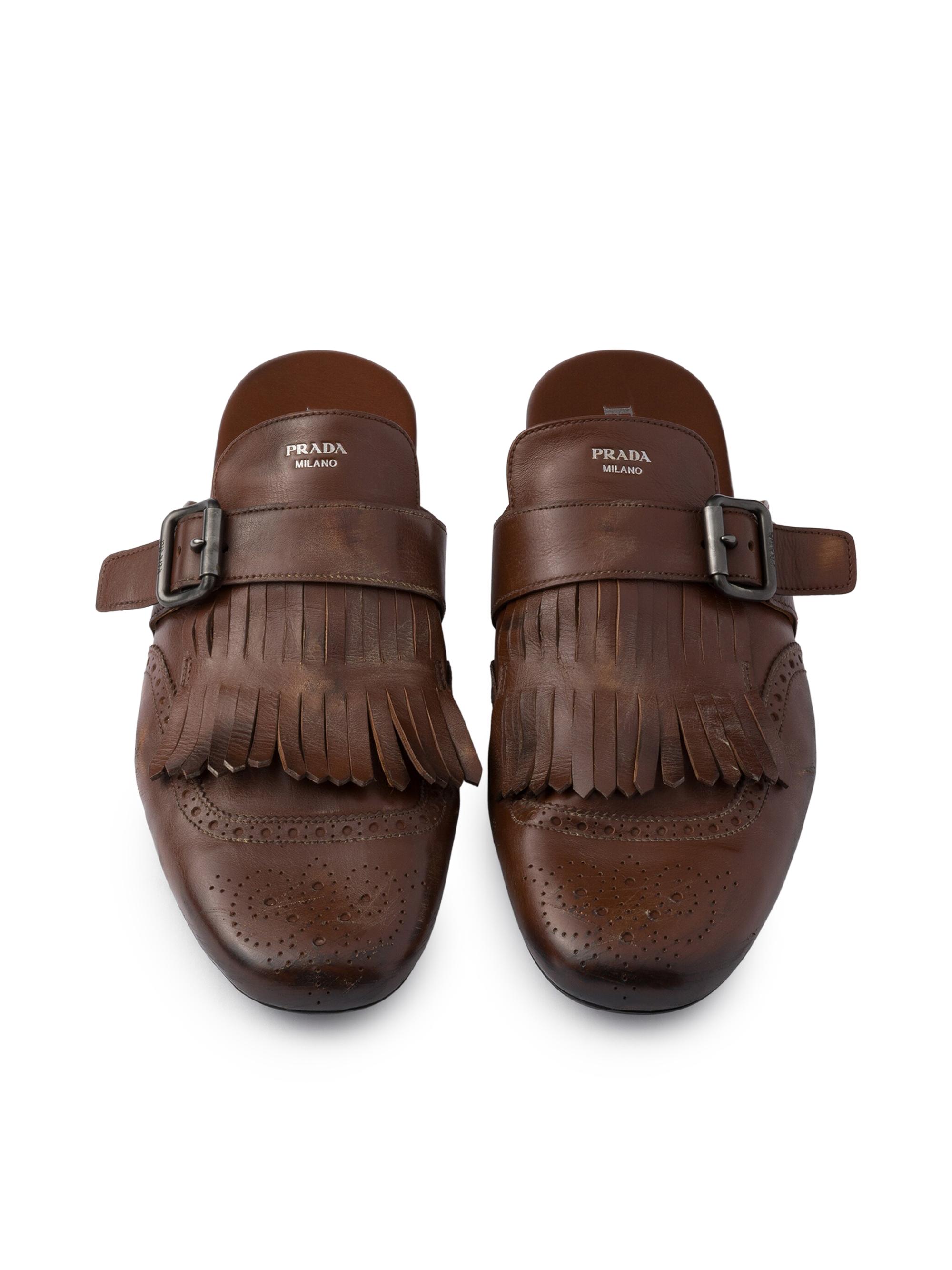 Prada Shuffle Antiqued Leather Mules with Buckled Strap and Fringe