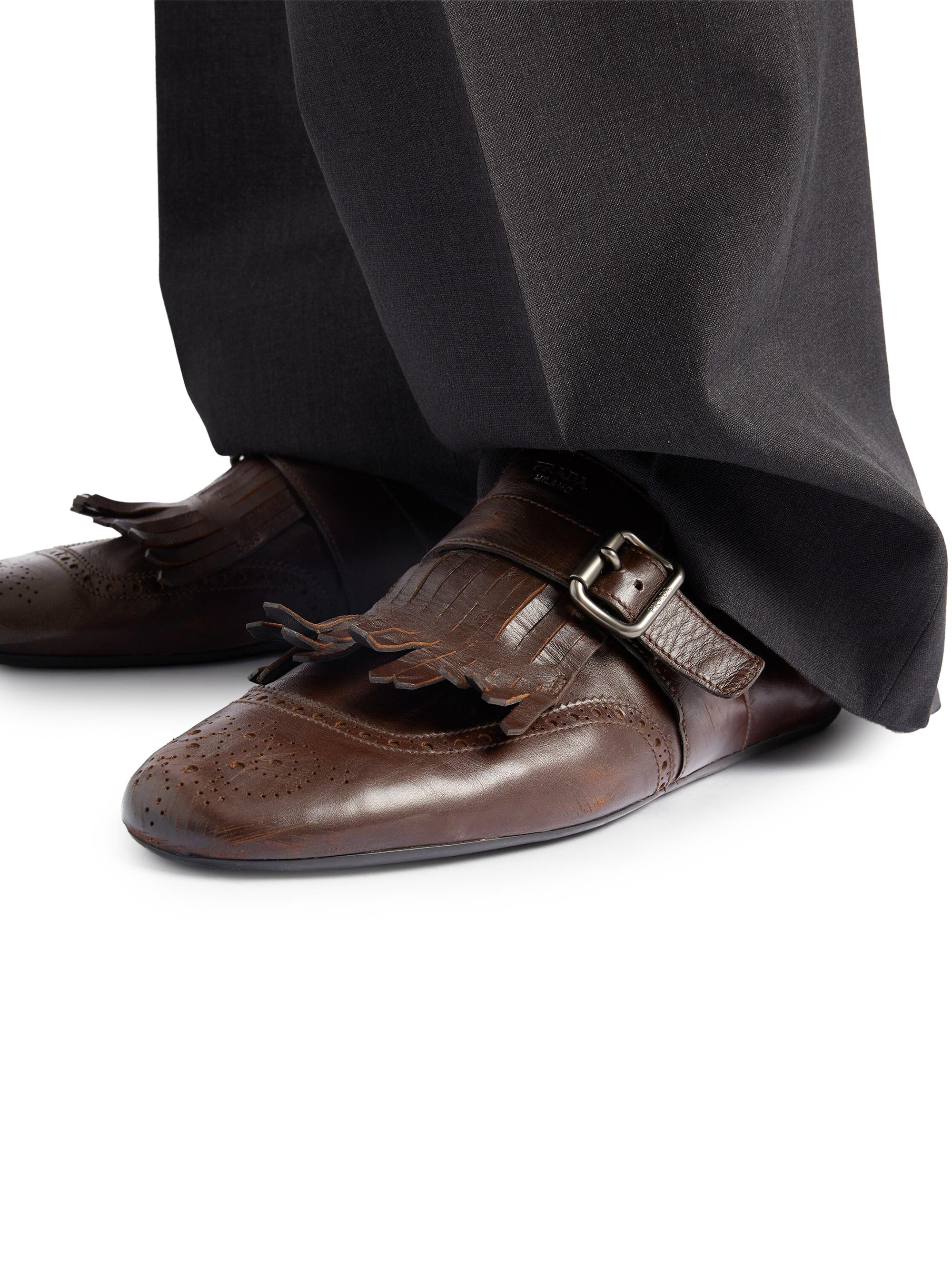 Prada Shuffle Antiqued Leather Mules with Buckled Strap and Fringe